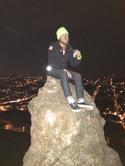 Joe sitting on a boulder
